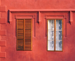 Ancient building with two large windows, color detail photography of vintage architecture