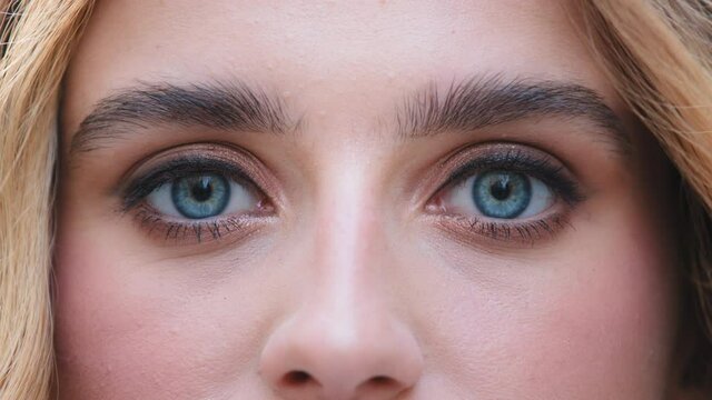 Close up of female face young caucasian girl looking at camera with beautiful blue eyes, attractive pretty woman lady with good vision sight eyesight with long eyelashes natural make-up, ophthalmology
