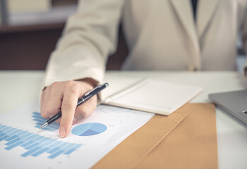 Business woman in suite working with documentary data on white desk at office, Business accounting and financial concept