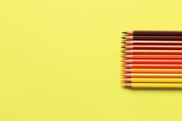 Colored pencils on a colored background. A set of pencils for drawing. Background from pencils.