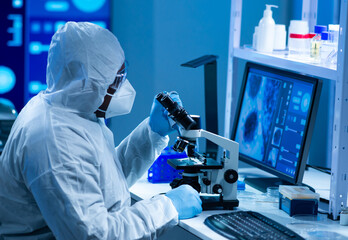 African-american scientist works in a scientific lab using laboratory equipment, microscope and computer technology. Invention of new drugs and vaccines. Concept of Science and Health.