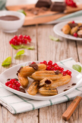 Mini churros with chocolate dipping sauce.