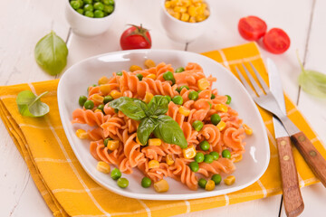 Fusilli pasta with peas and sweet corn.