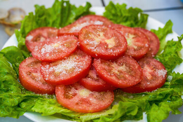 A plate of fresh white sugar tomato slices, cold dishes