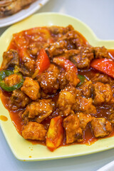Closeup of a delicious sweet and sour pork ribs in tomato sauce