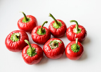 beautiful red mini peppers on a light background