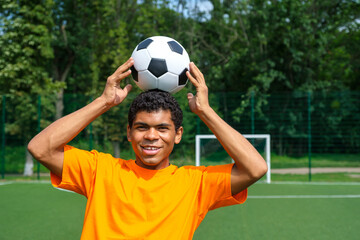 Brazilian soccer player trains and improves soccer ball control by juggling it on his head on sport...