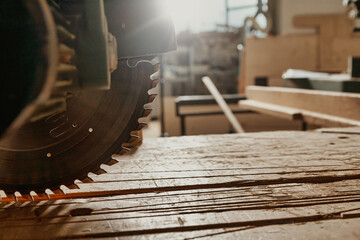 Close up on the blade of a circular power saw in a workshop