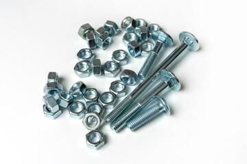 pile of bolts and nuts on white background with copy space