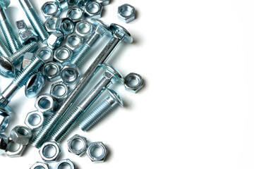 pile of bolts and nuts on white background with copy space