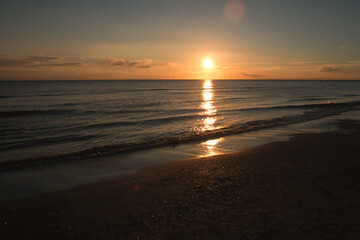 Fototapeta na wymiar Sunset on the beach of Blåvand in Denmark. Walking in the evening in great light atmosphere
