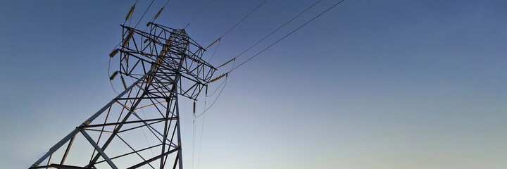 Electric station with wires standing on background of sunset closeup