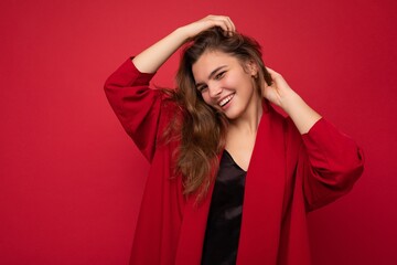 Photo portrait of beautiful happy smiling young brunet woman in stylish red cardigan. Sexy carefree...