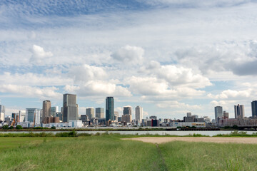 Obraz premium View of office buildings of central Osaka city from Yodogawa river bank