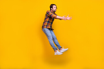 Fototapeta na wymiar Full length photo of sad brunet millennial guy fall wear shirt jeans sneakers isolated on yellow background
