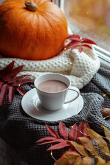 Atmospheric composition of autumn with a cup of cocoa, pumpkin and autumn leaves