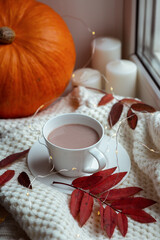 Atmospheric composition of autumn with a cup of cocoa, pumpkin and autumn leaves
