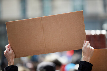 Protesters holding placards and signs on the streets.