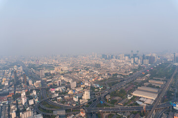 Landscape of the top view Bangkok metropolis Thailand with the dirty clouds air pollution problem. the tower and building with road line in business area