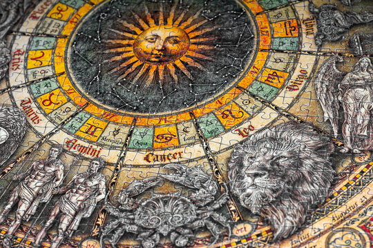 Orenburg, Russia-September 22, 2021; collected a picture from puzzles, on the topic of astrological signs of the zodiac circle and a photo frame on top