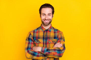 Fototapeta premium Photo of sweet charming young man wear plaid shirt smiling hands folded isolated yellow color background