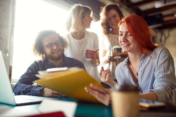 Group of young colleagues are in a good mood while working together in the office
