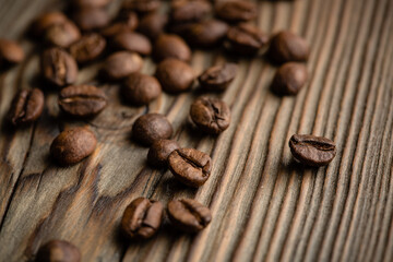 Coffee seeds on grunge wooden background close up. High quality photo
