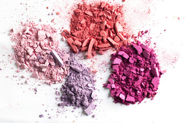 Cosmetic texture background. Broken eye shadows. Pink magenta decorative cosmetics 