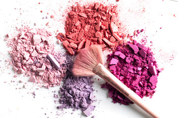 Cosmetic texture background. Broken eye shadows. Pink magenta decorative cosmetics 