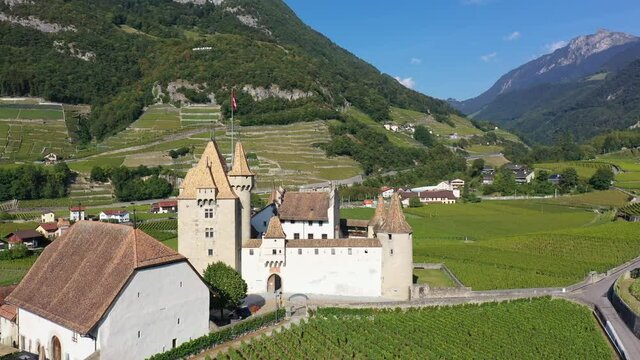 Aerial drone footage of the Aigle castle in the middle of vineyards in Canton Vaud in Switzerland. Shot with a rotation motion