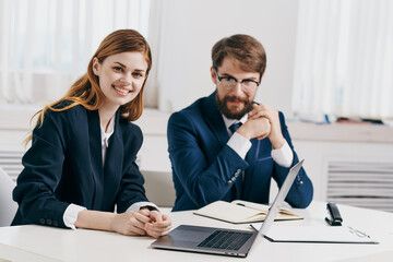 man and woman managers work together in front of laptop team technology