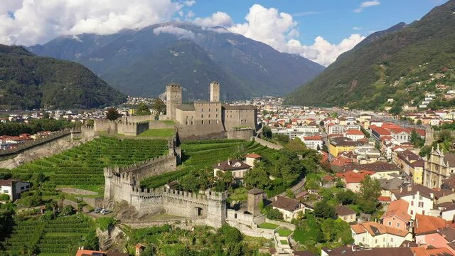 Aerial drone footage of Bellinzona old town and the Castelgrande medieval castle in Canton Ticino in Switzerland. Shot with a rotation motion. 