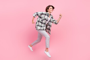 Full body profile side photo of young woman happy positive smile jump go walk run fast isolated over pink color background