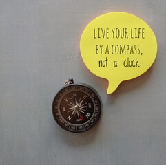 Motivational and inspirational quotes. Compass and yellow bubble speech with quotes LIVE YOUR LIFE...