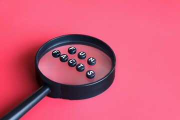 Magnifying glass and alphabet beads with text FUN FACTS