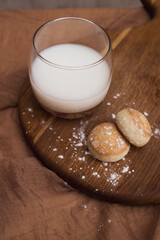 Milk in a glass on a wooden board close up