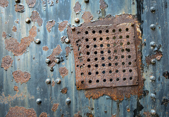 Close up of old rusty metal door at abandoned Army base at Fort Flagler State Park, Washington.