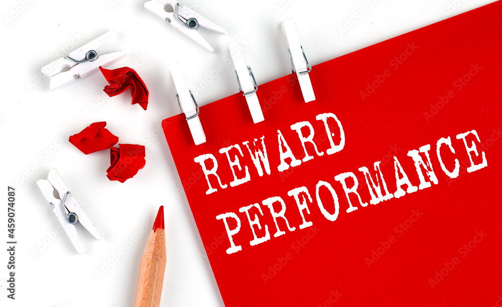 Poster reward performance text on red paper with office tools on white background