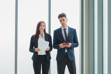 Portrait of adult business man and woman in formal work suit outfit walking and discuss about company investment