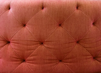 Close up of red fabric sofa. For using as background and pattern.