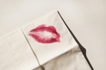 Pink lipstick on a napkin