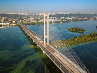 South bridge in Kiev. Algae bloom in the water of the Dnieper River. Aerial drone view.