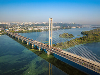 South bridge in Kiev. Algae bloom in the water of the Dnieper River. Aerial drone view.