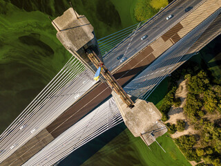 South bridge in Kiev. Algae bloom in the water of the Dnieper River. Aerial drone view.