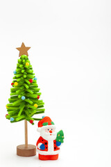 Little Santa Claus toy with decorative green beautiful handmade New year tree isolated on white background. christmas and new year concept