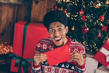 Fototapeta premium Photo portrait smiling excited man keeping letter for santa claus on xmas holidays having a wish