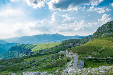 Fototapeta na wymiar Mountains peaks of the Durmitor National Park, along which picturesque high-mountain tourist road of northern Montenegro passes. UNESCO World Heritage site. Beautiful summer cloudy landscape.