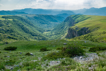 Fototapeta na wymiar Mountains peaks of the Durmitor National Park, along which picturesque high-mountain tourist road of northern Montenegro passes. UNESCO World Heritage site. Beautiful summer cloudy landscape.