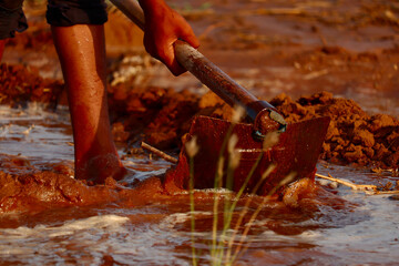 man working in garden between beds with hoe in hands,Young Indian Farmer water the field,selective focus,Indian farmer working in farm with hoe,