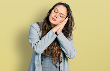Young hispanic girl wearing business clothes and glasses sleeping tired dreaming and posing with...